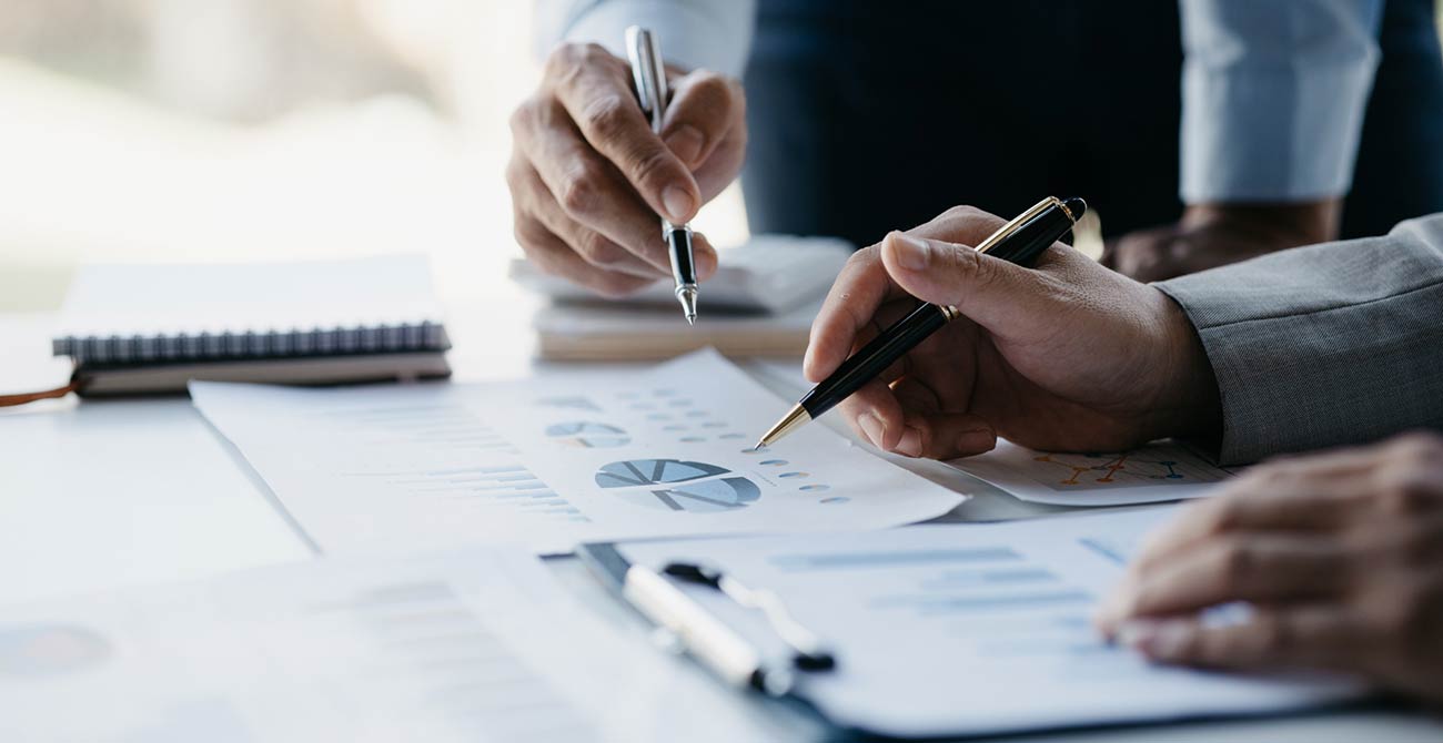 Closeup of Two People Going over Financials